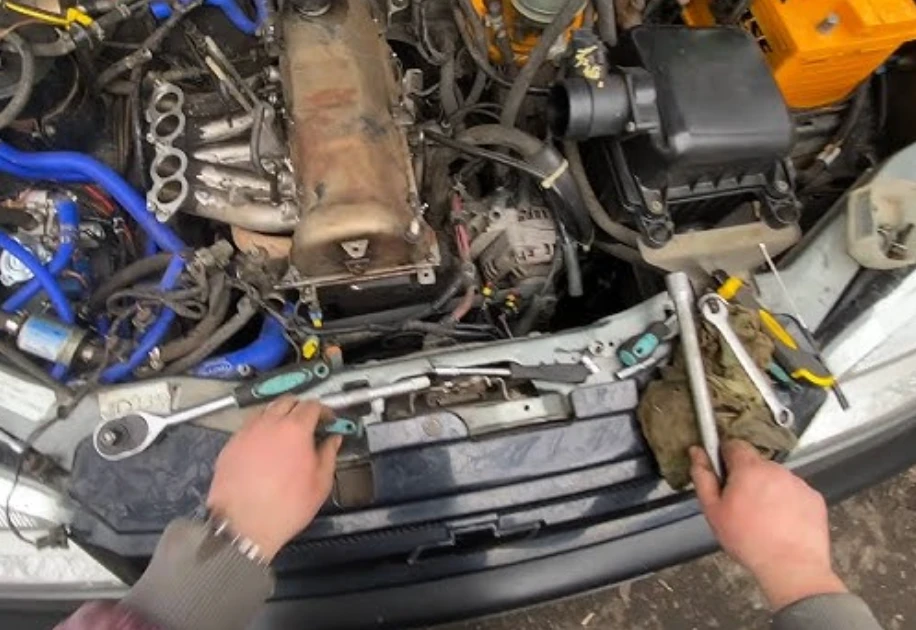 First-person view of an auto mechanic working on an engine